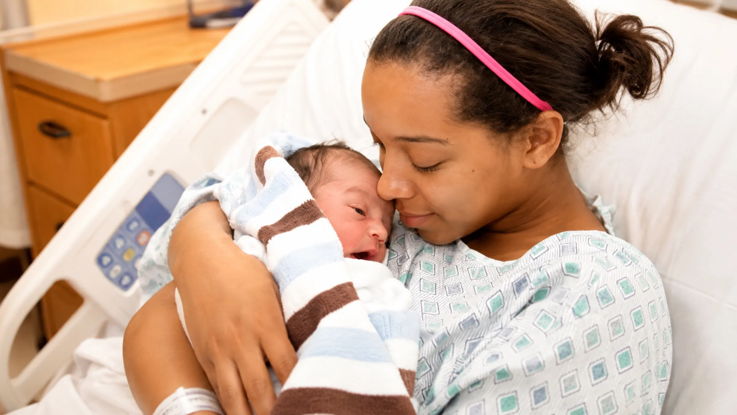 A young mother holding her newborn baby