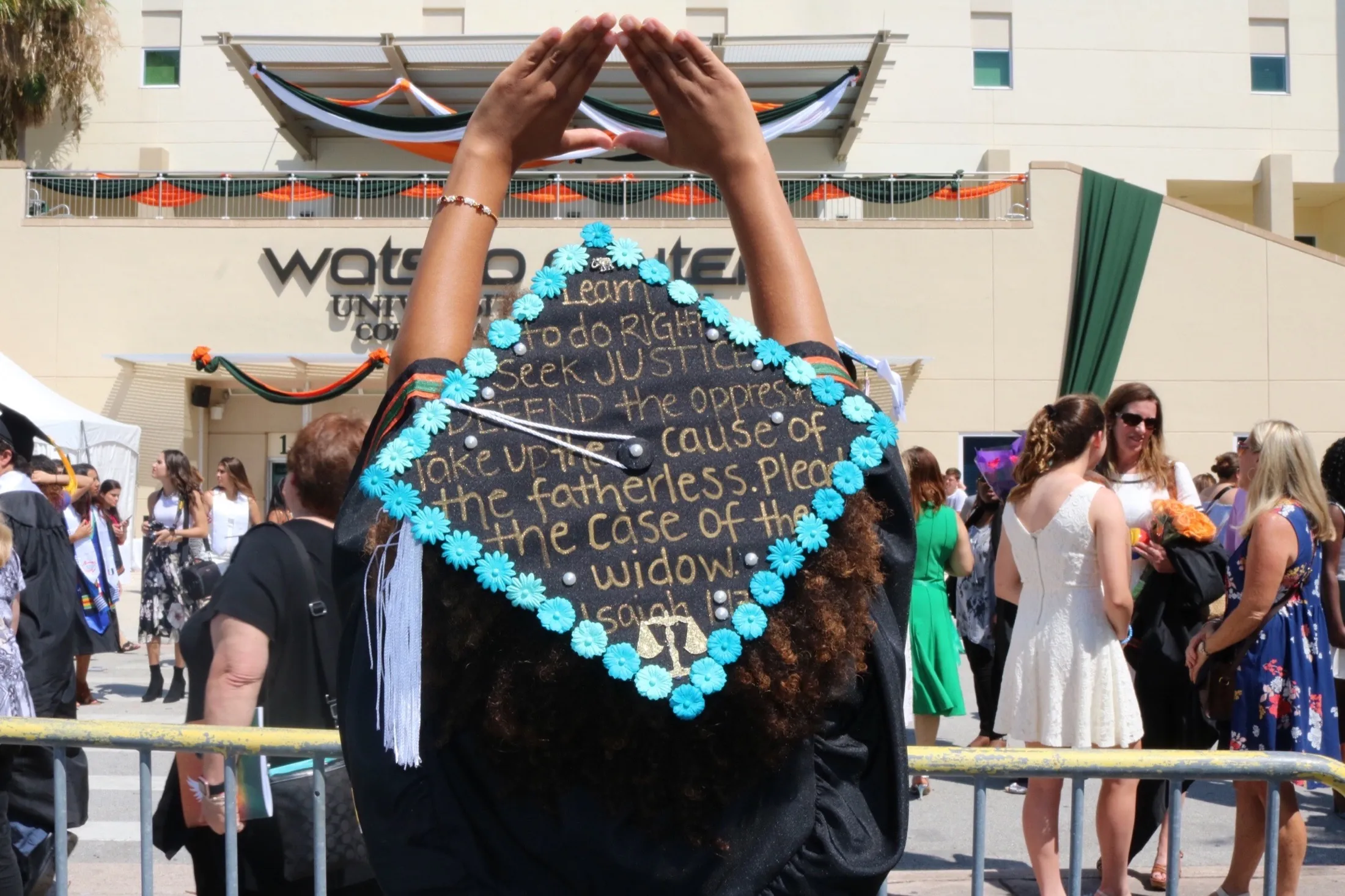 Celebrating graduation in a decorated cap and gown