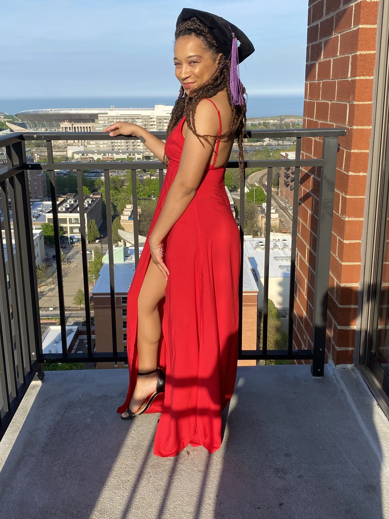 Celebrating a graduation in a red dress and doctoral cap